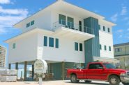 Modern coastal piling home in Navarre by Acorn Fine Homes