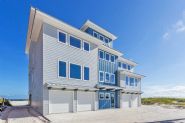 Modern coastal piling home in Navarre by Acorn Fine Homes