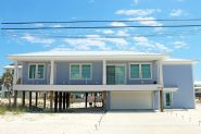 Modern coastal piling home in Navarre by Acorn Fine Homes