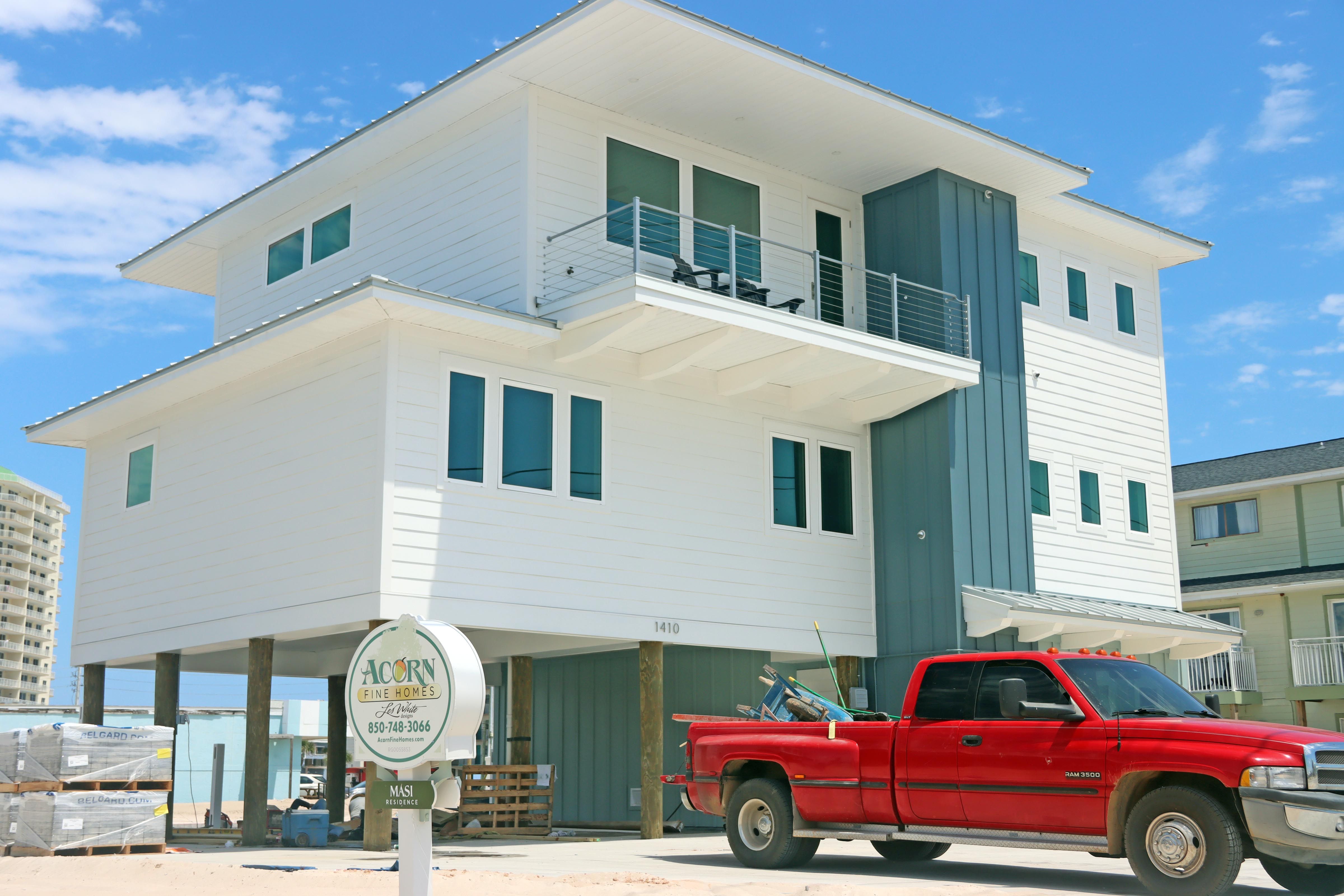 Modern coastal piling home in Navarre by Acorn Fine Homes