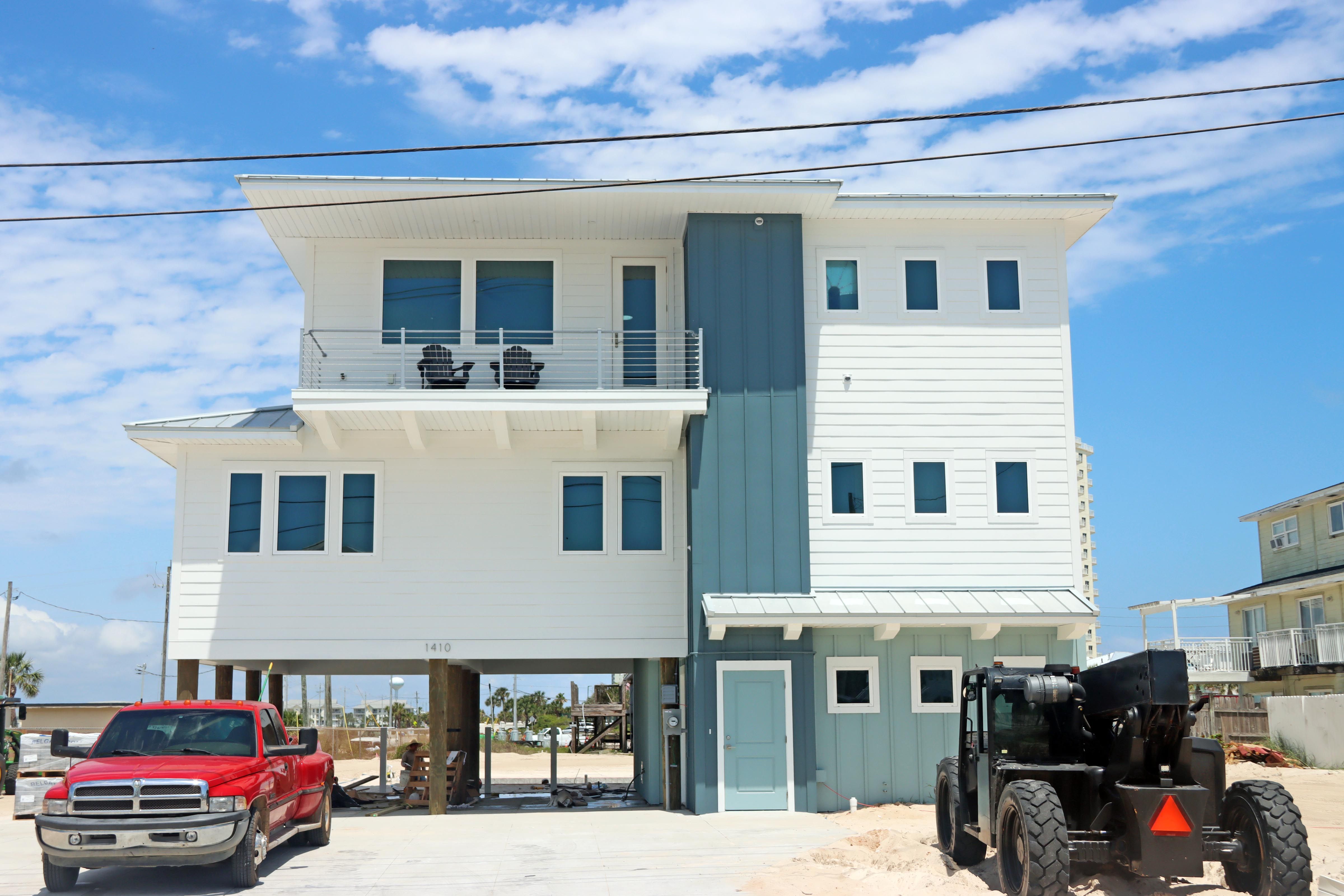 Modern coastal piling home in Navarre by Acorn Fine Homes