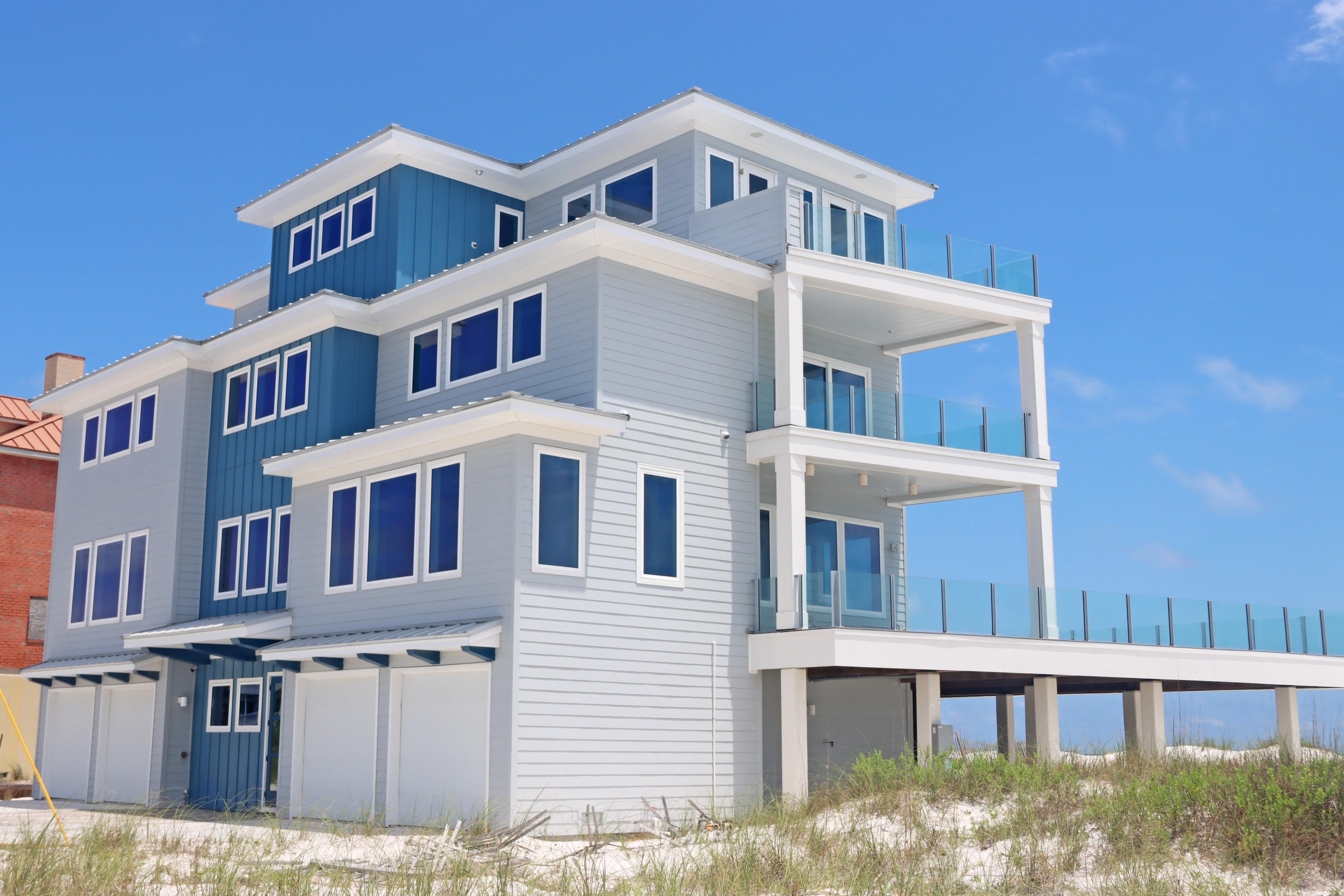 Modern coastal piling home in Navarre by Acorn Fine Homes