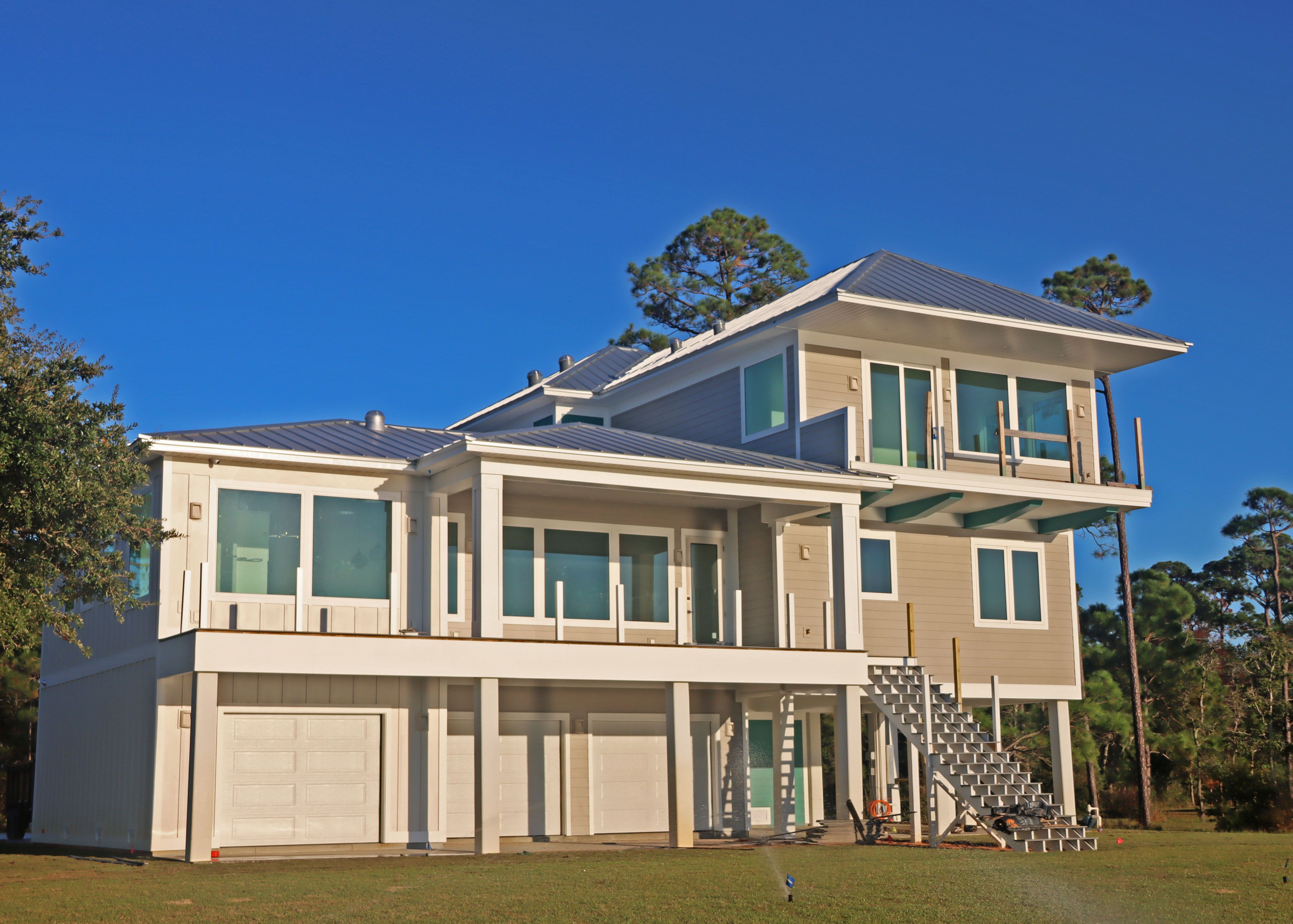 Modern piling home in Navarre, Gulf Breeze, Milton by Acorn Fine Homes