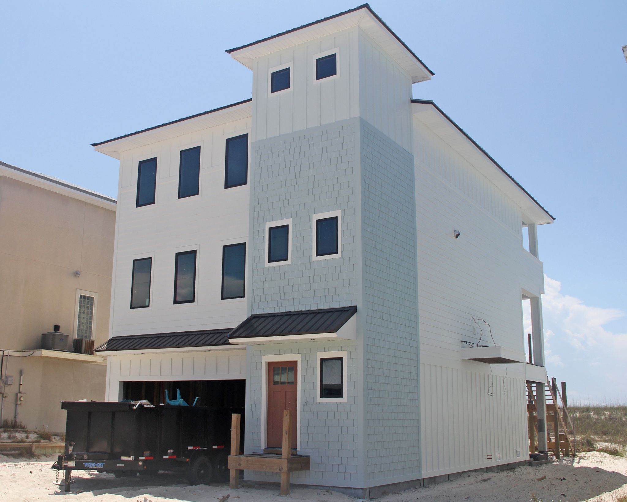 Davis modern coastal piling home on Navarre Beach by Acorn Fine Homes