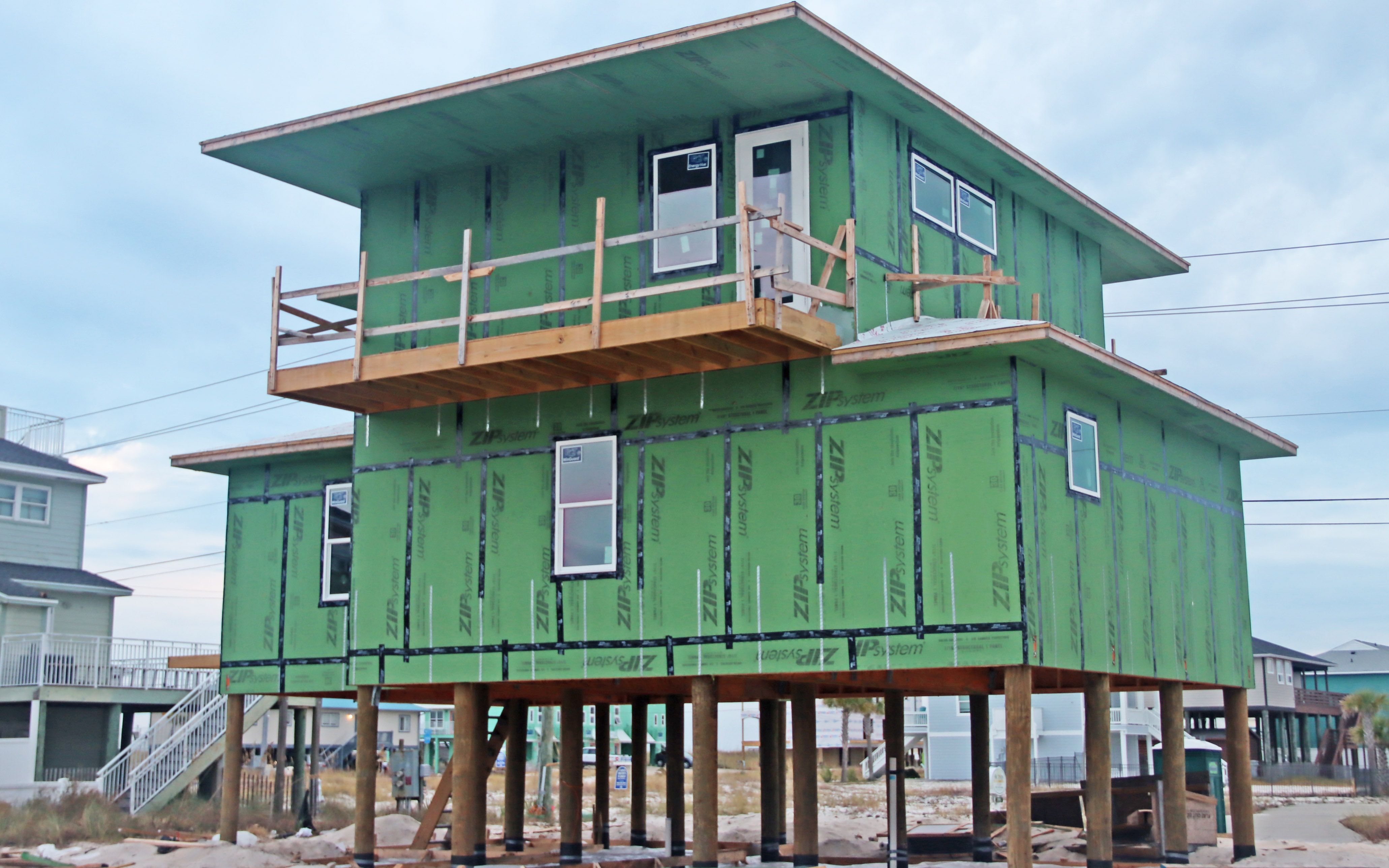 Masi modern coastal piling home in Navarre by Acorn Fine Homes