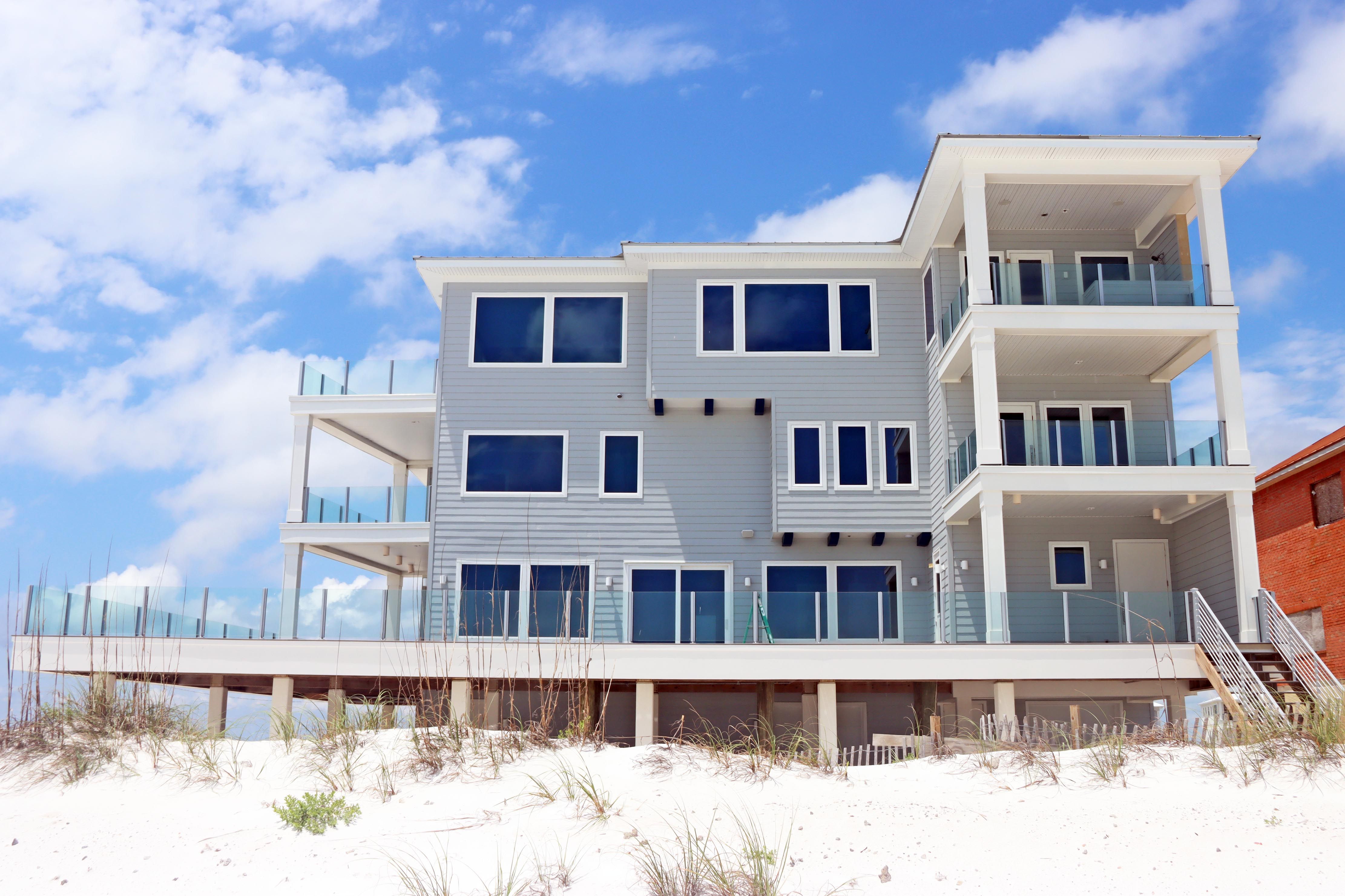 Modern coastal piling home in Navarre by Acorn Fine Homes