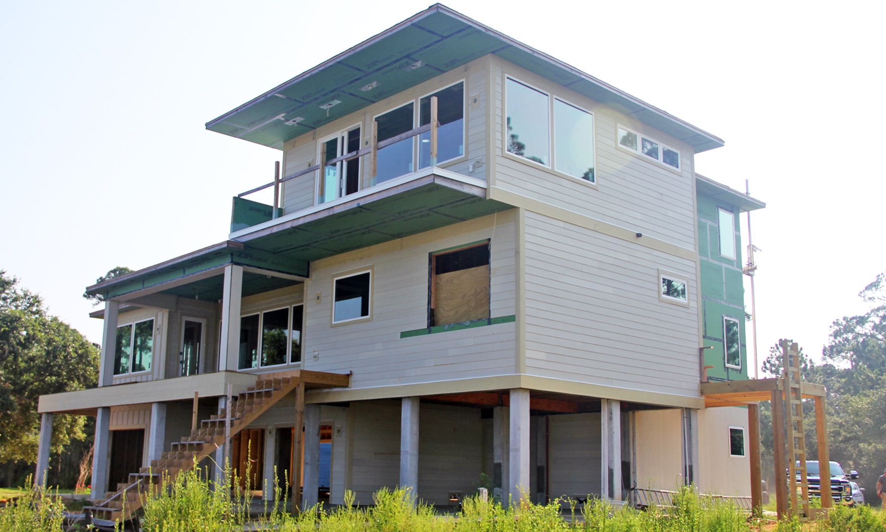 Modern piling home in Navarre by Acorn Fine Homes