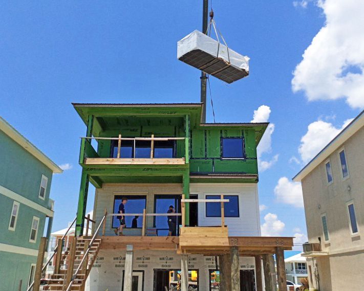 Davis modern coastal piling home on Navarre Beach by Acorn Fine Homes